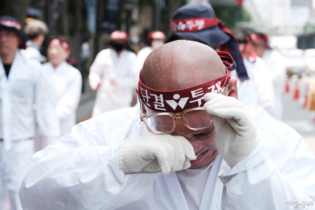 덥다 더워, 혼잣말이 잦다. 진짜 덥네요, 인삿말이 흔하다. 말도 못 하게 덥다고 인사에 답한다. 말하지 않아도 잘 아는 그 처지를 굳이 말로 나누면서 사람들은 얼마간의 위로를 주고받는다. 여름 햇볕은 꽤나 공평한 것이어서, 길에 선 누구나가 더웠다. 덥다고 멈출 수 없는 일을 하느라 사람들은 땀 흘린다. 밥을 벌고, 법을 요구하고, 불법을 규탄한다. 바닥을 기고, 길에 앉아 버티고, 때로는 선 채로 말하기를 계속한다. 헐떡거리며 한낮을 견딘다. 어쩌다 찾은 그늘에서 위안을 얻는다. 바람 귀한 줄을 깨닫는다. 얼음물과 모자와 팔토시, 또 양산을 챙겨 태양과 싸운다. 또 온갖 것과 싸우느라 이 여름에 열기 더 높다. 이제 시작일 뿐이라고, 역대급으로 센 것이 기다린다는 어느 전문가의 말에 좌절도 잠시. 우리는 방법을 찾을 것이다. 오랜 투지가 식을 줄을 모른다. 여름 풍경이다. <정기훈 기자>