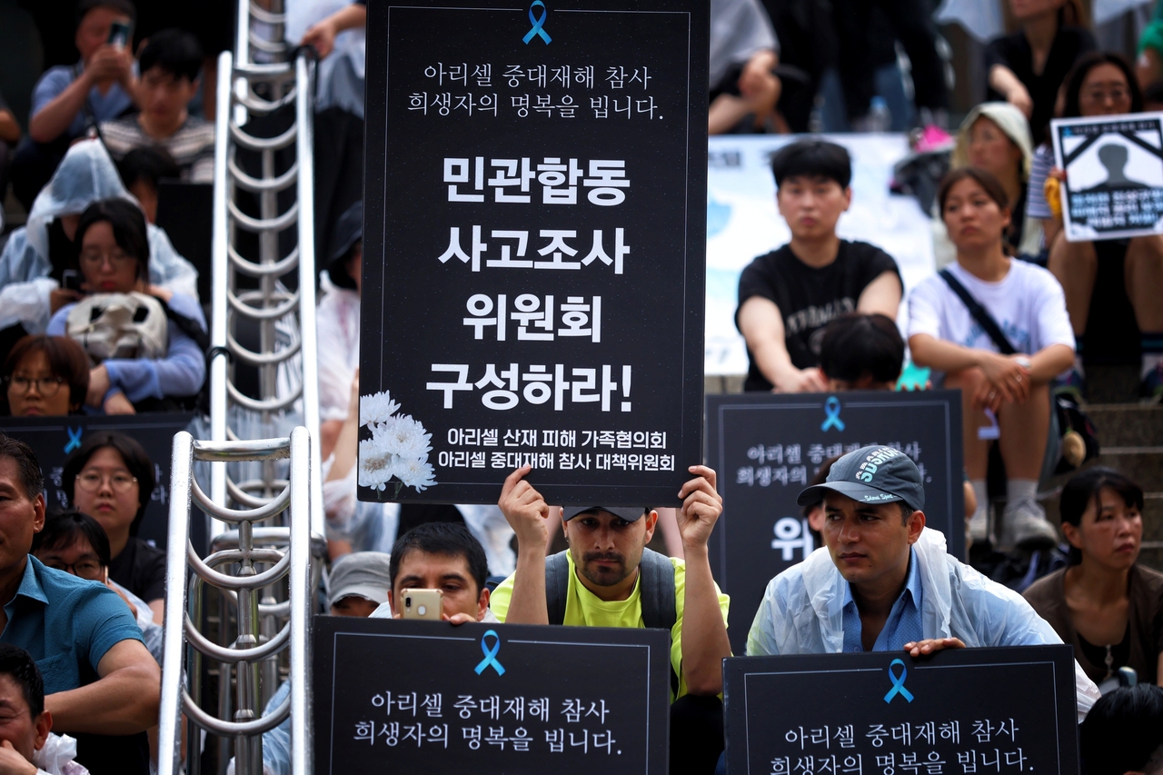 ▲ 시민문화제에 참여한 이주노동자들이 제대로 된 진상규명을 촉구하는 선전물을 들고 있다. <윤성희 기자>